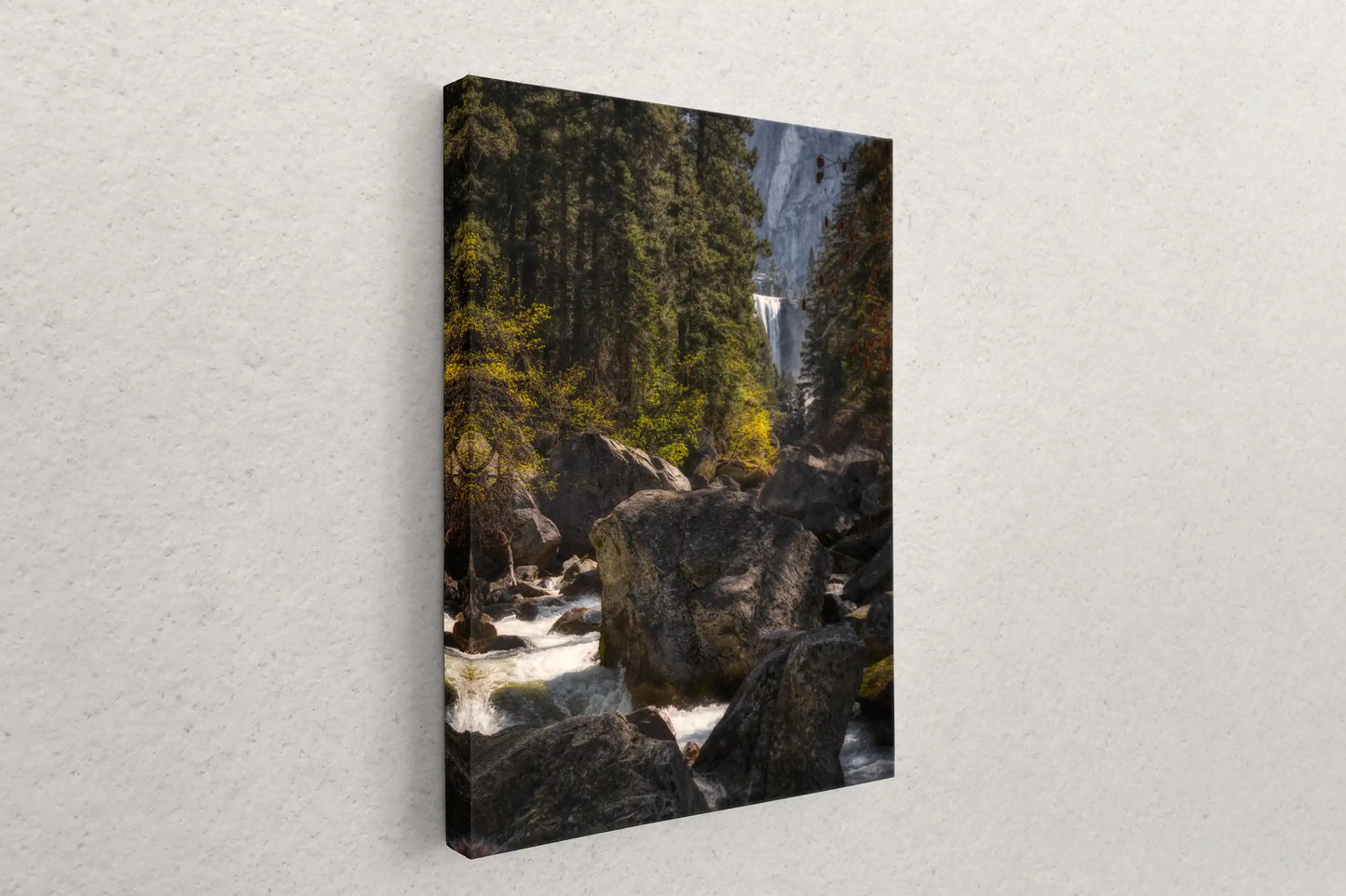 A canvas print mounted on a wall showcasing Vernal Falls in Yosemite, offering a natural touch to the room.