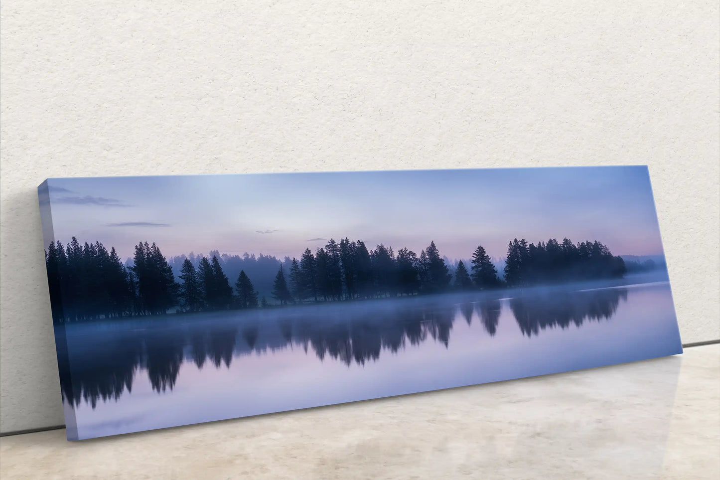 Front-leaning canvas artwork of Yellowstone Lake's serene sunrise, with mist-shrouded trees reflecting in still waters, symbolizing peace and stillness.