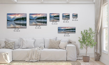 Different sizes of Yellowstone Lake sunrise canvas prints displayed over a sofa for size comparison.