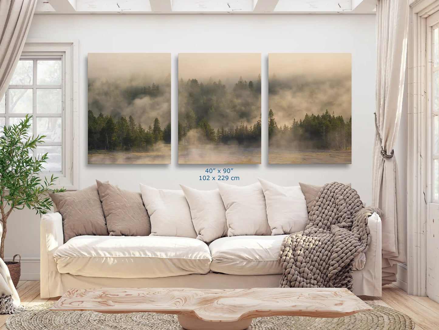 An expansive 40x90 triptych canvas print of a foggy forest in Yellowstone, serving as a stunning focal point in a spacious living room.