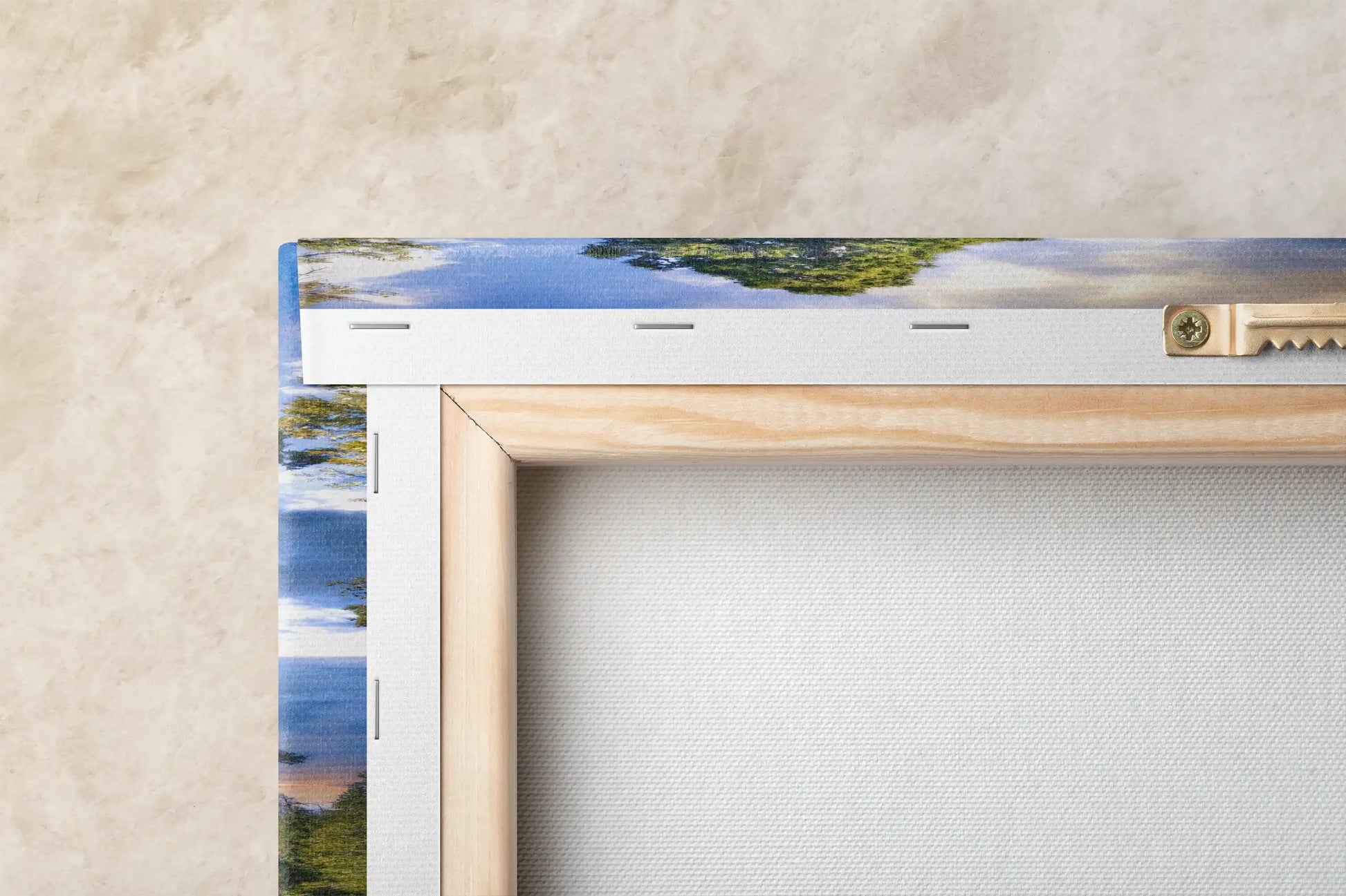 Close-up of a canvas print's back frame and mounting hardware, focusing on the construction and hanging mechanism.