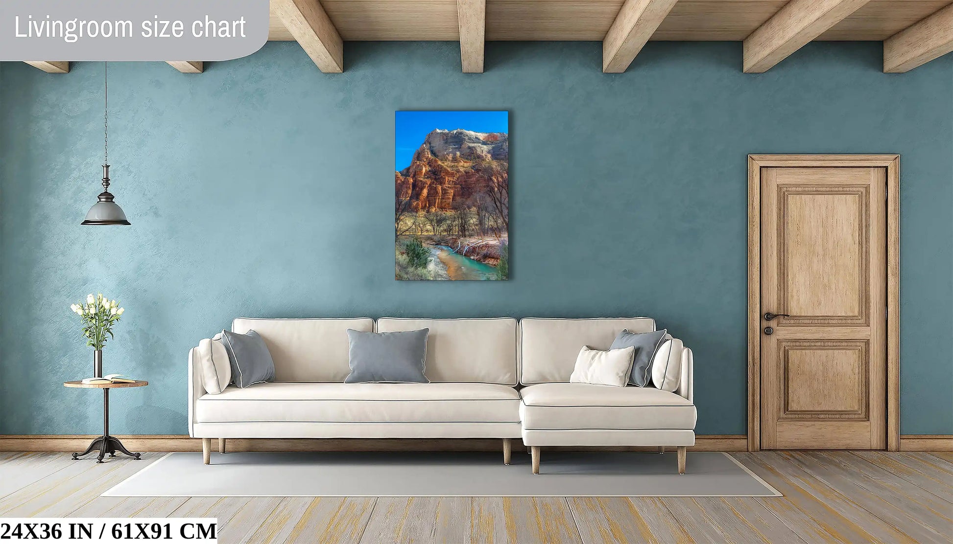 A 24x36 inch canvas print on a living room wall captures the rugged beauty of Zion National Park's landscape.