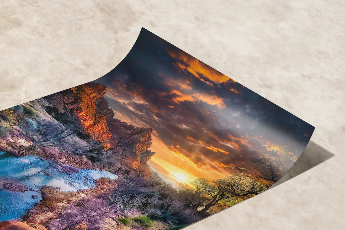 Curved paper print capturing Zion National Park's Watchman Mountain at sunset, with vivid clouds above and a serene river below.