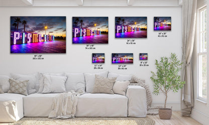 Various sizes of the Pismo Beach neon sign wall art displayed in a living room setting, from 8x10 to 40x60, showcasing the colorful artwork against a twilight sky.