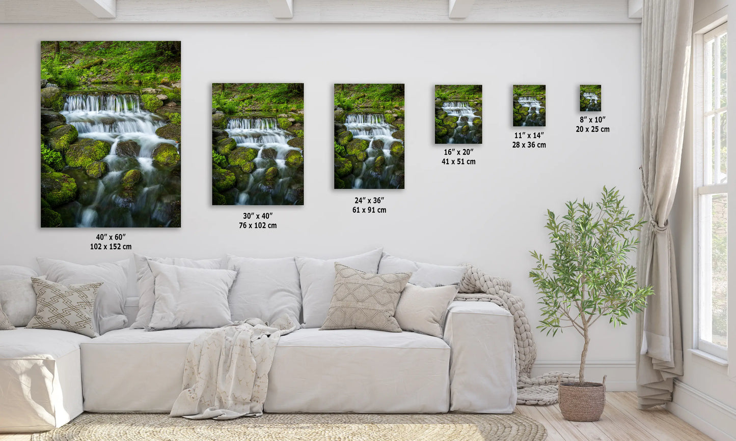 a living room with a white couch and three pictures on the wall