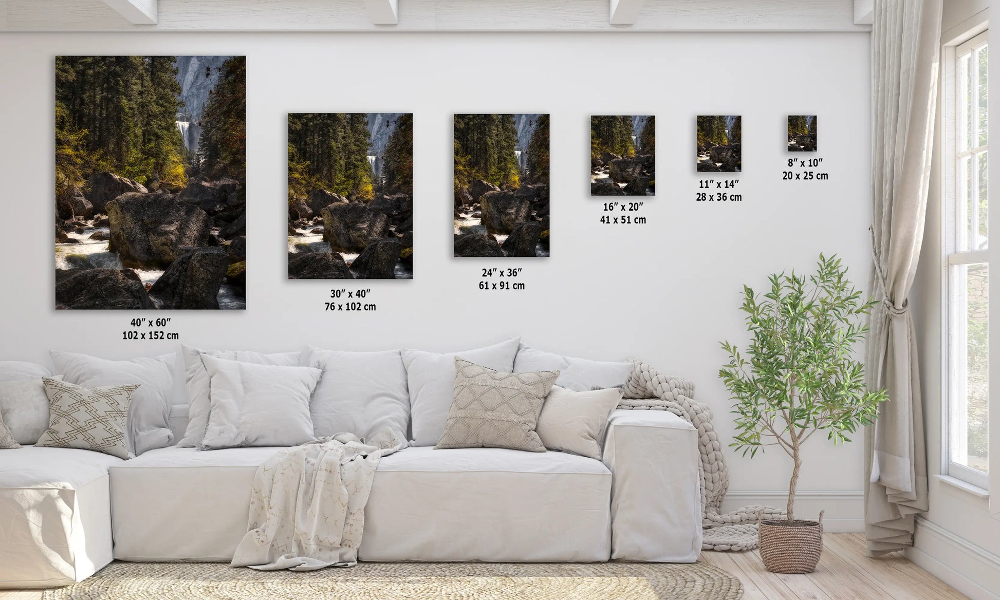 a living room with a white couch and three pictures on the wall