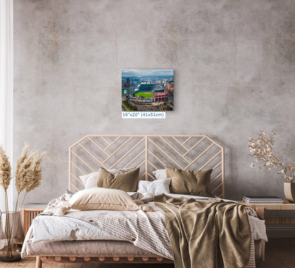 a bedroom with a large bed, a wooden headboard, and a framed picture of a cityscape hanging on the wall above the bed.