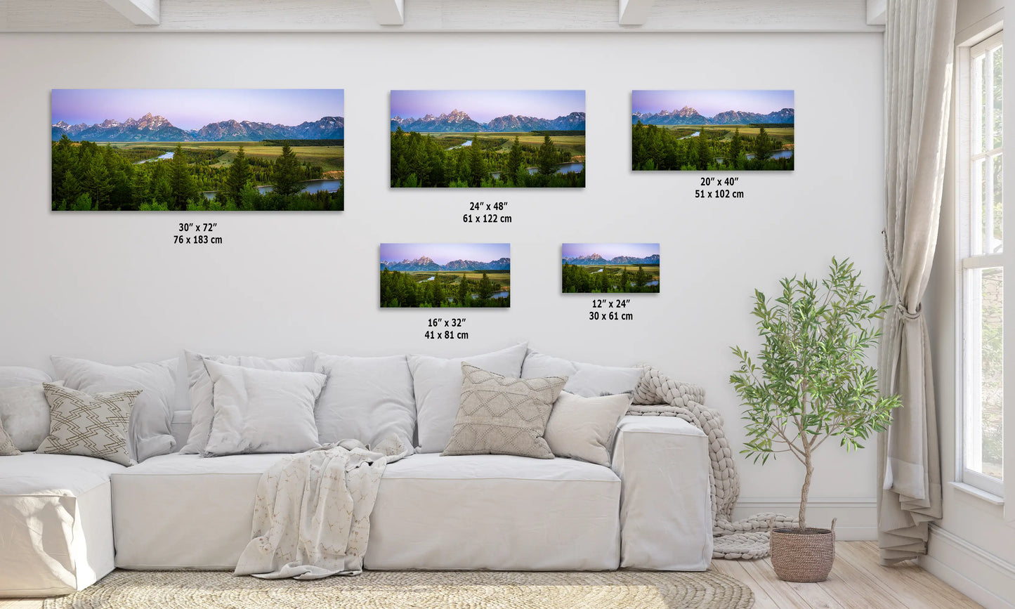 a living room with a white couch and four pictures on the wall