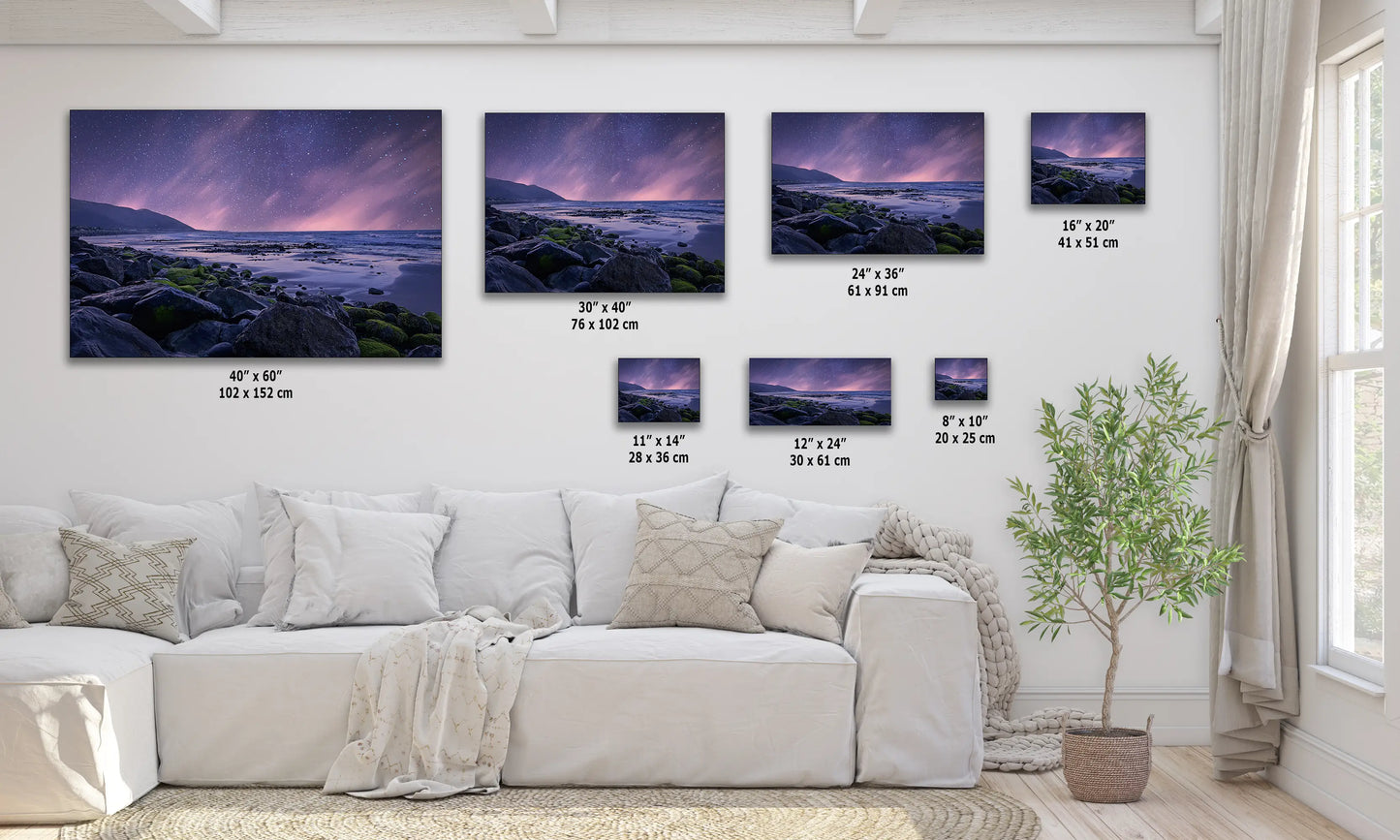 a living room with a white couch and four pictures on the wall