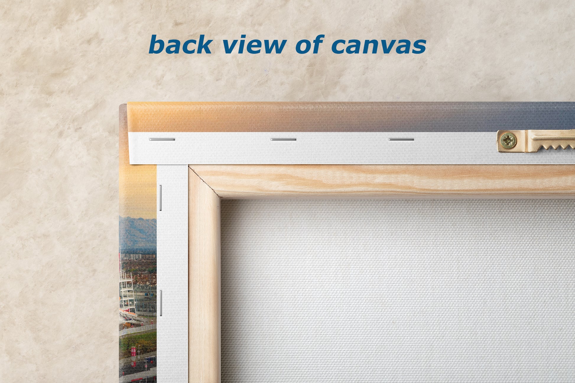 a back view of a canvas, with a wooden frame and a metal bracket attached to the wall.