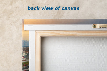 a back view of a canvas, with a wooden frame and a metal bracket attached to the wall.