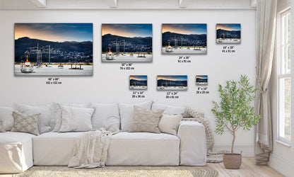 a living room with a white couch and pictures on the wall