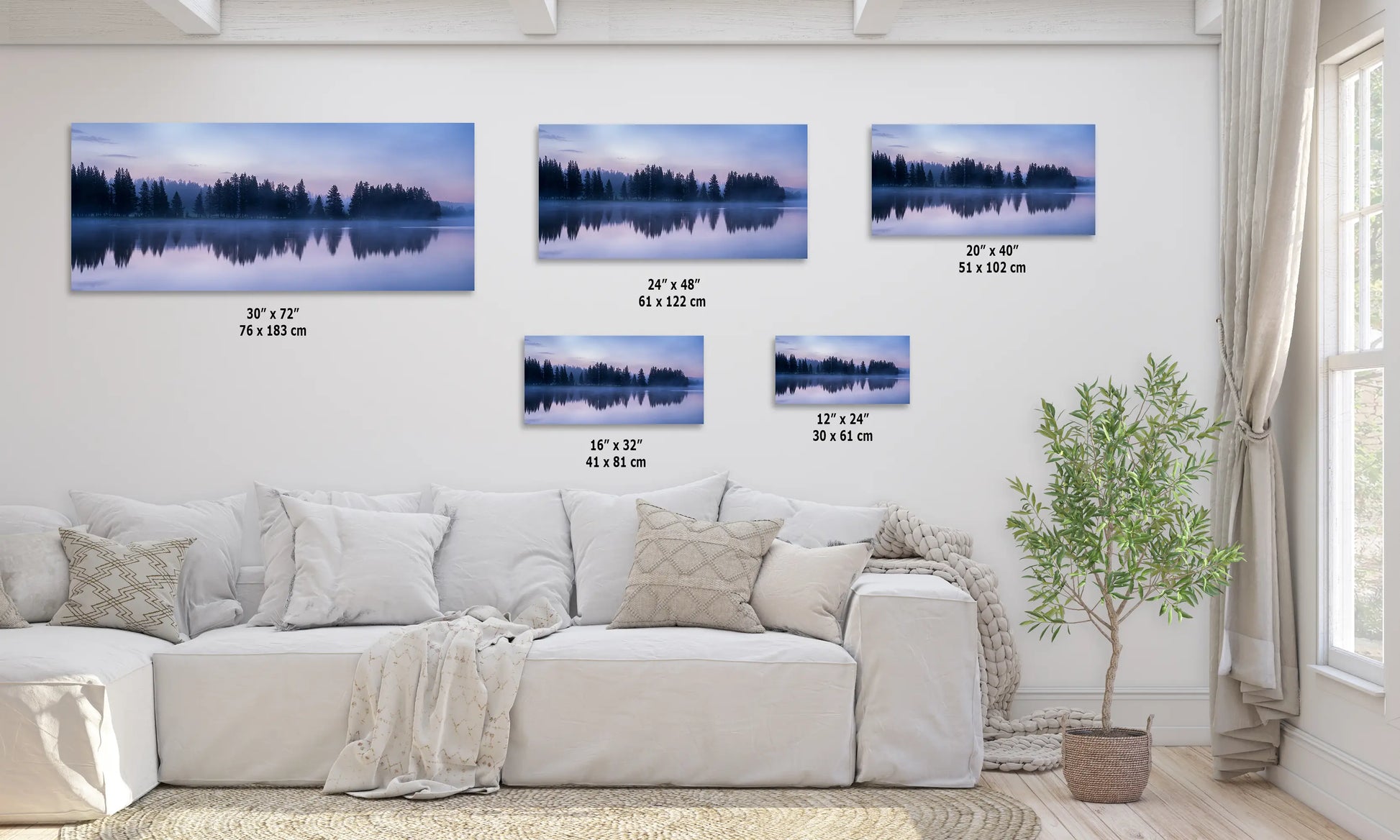 a living room with a white couch and three paintings on the wall