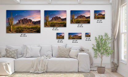 a living room with a white couch and paintings on the wall